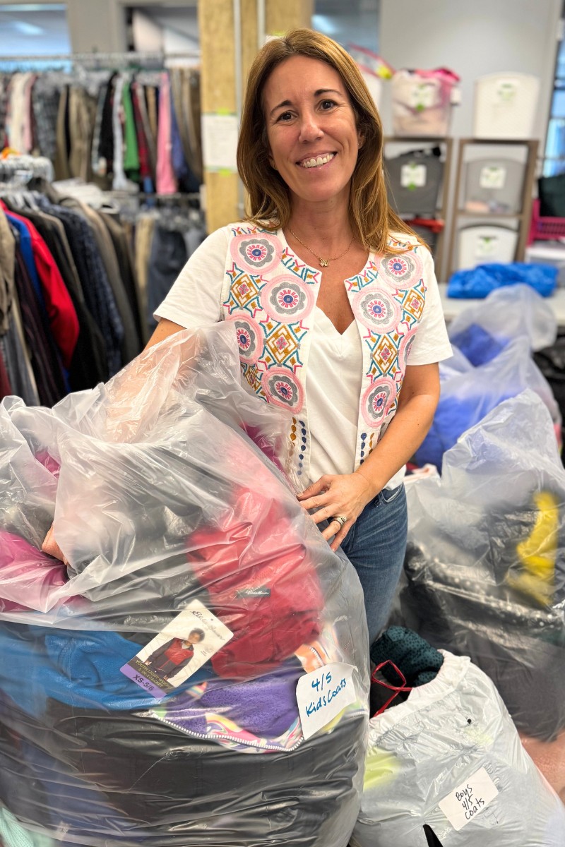 woman holding bags of clothes